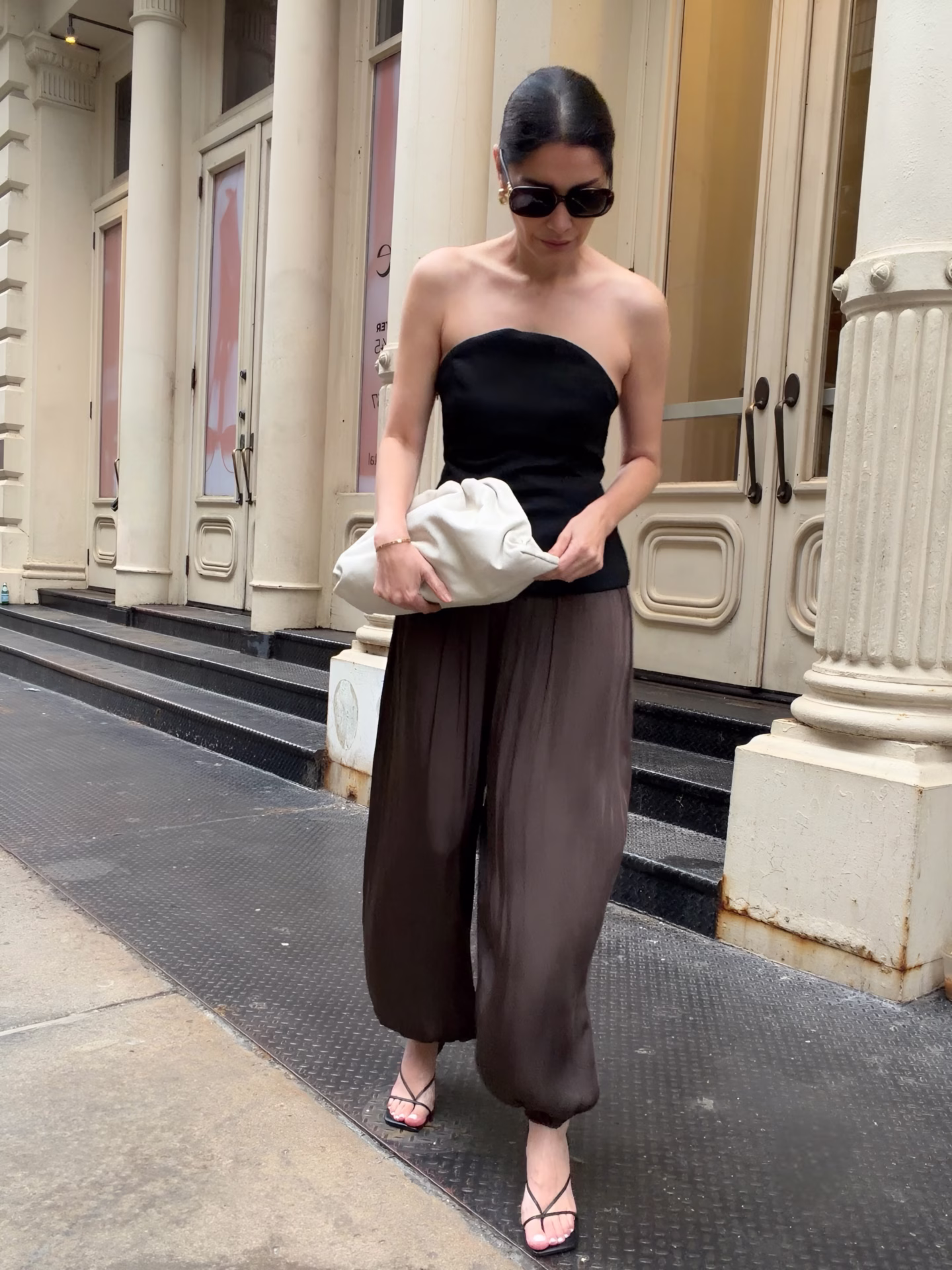 Balloon Hem Pants with black bandeau top and black strappy heels with a bottega veneta neutral color pouch