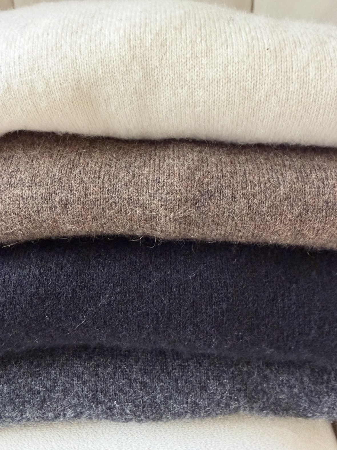 Quince clothing review: a stack of my collection of cashmere sweaters