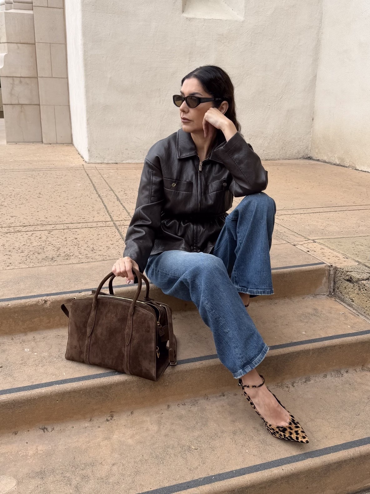 Wearing my Chocolate Brown Suede Gabrielle 35 Bag with jeans, a faux leather jacket, and animal print heels.